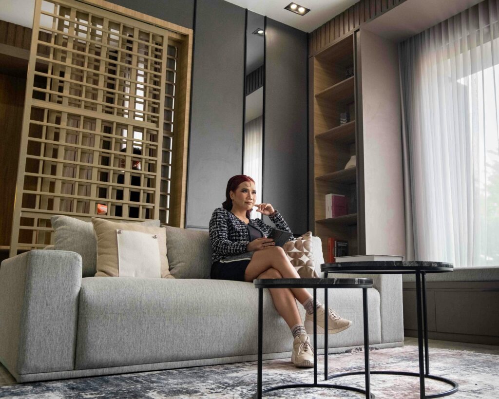 Woman relaxing on sofa in a modern living room